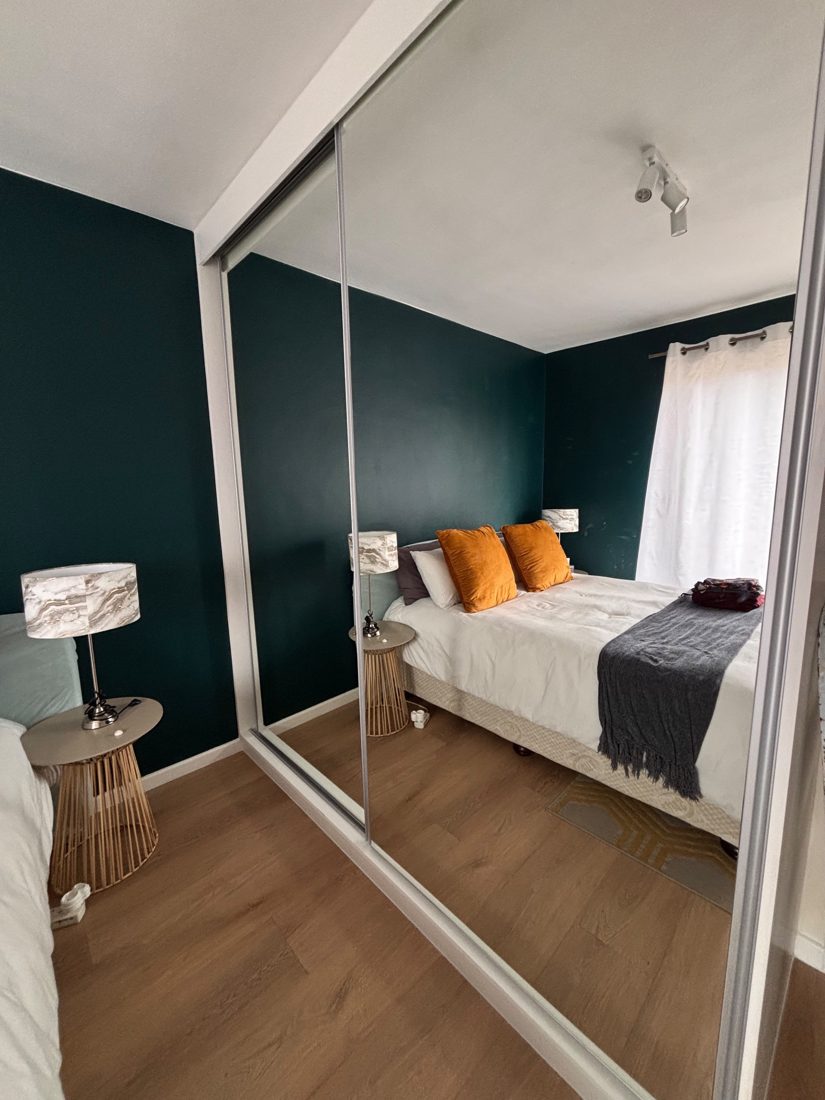 The same sliding doors after full-height mirrors were fitted, reflecting the bedroom